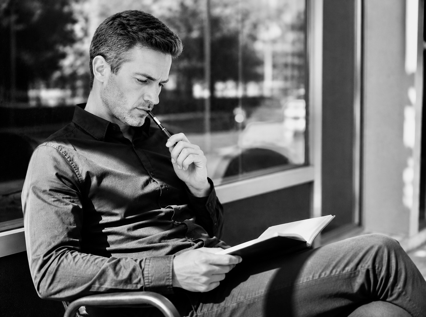 Man reading and reflecting